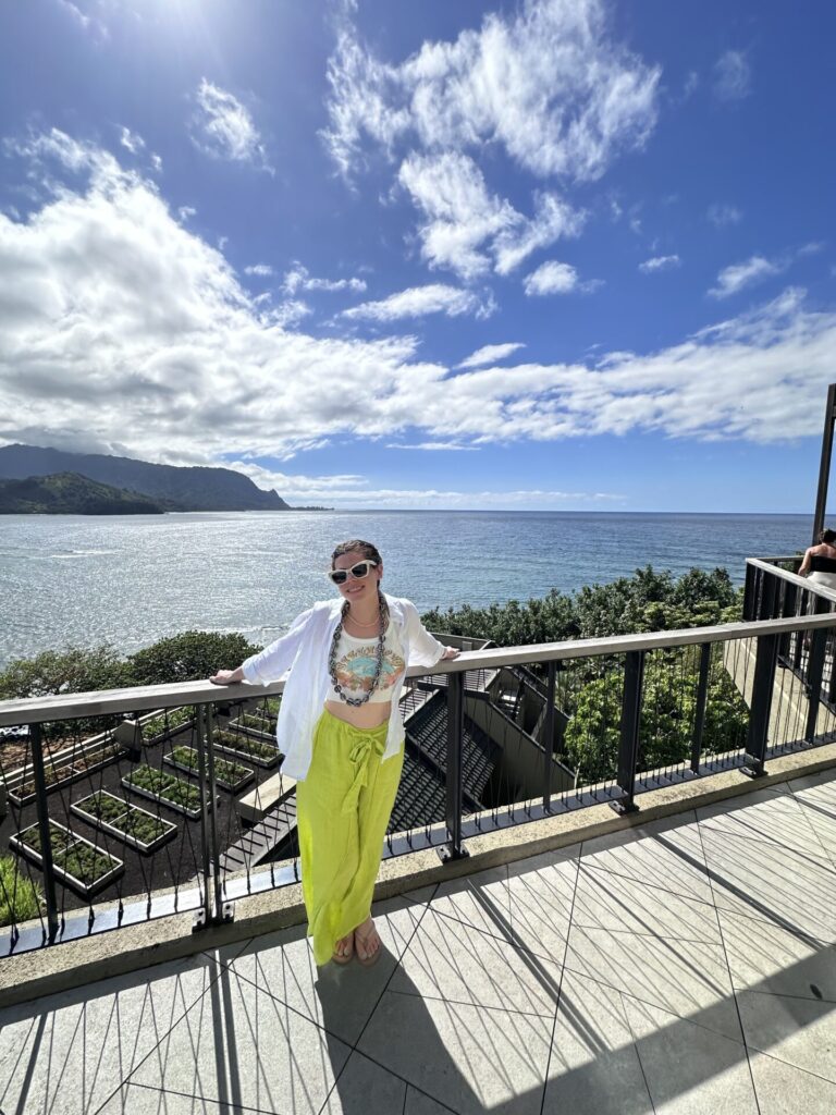 Natalie in lime green pants and button-down On the terrace of the 1 hotel Hanalei bay in kauai
